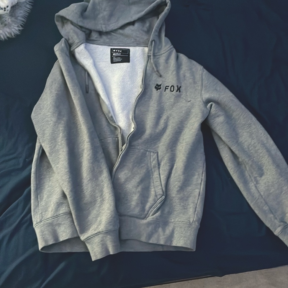 It is a grey zip up jacket, it has been used but it is in good condition.